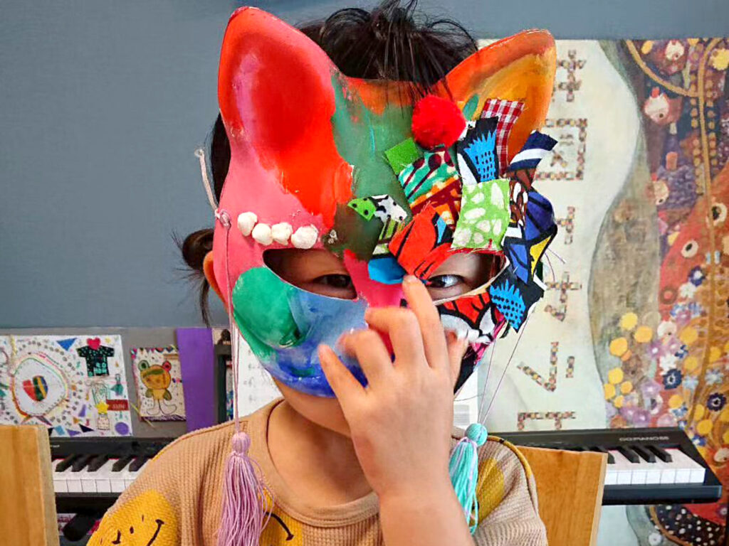 一番の人気作品・猫のおめんを被る子ども